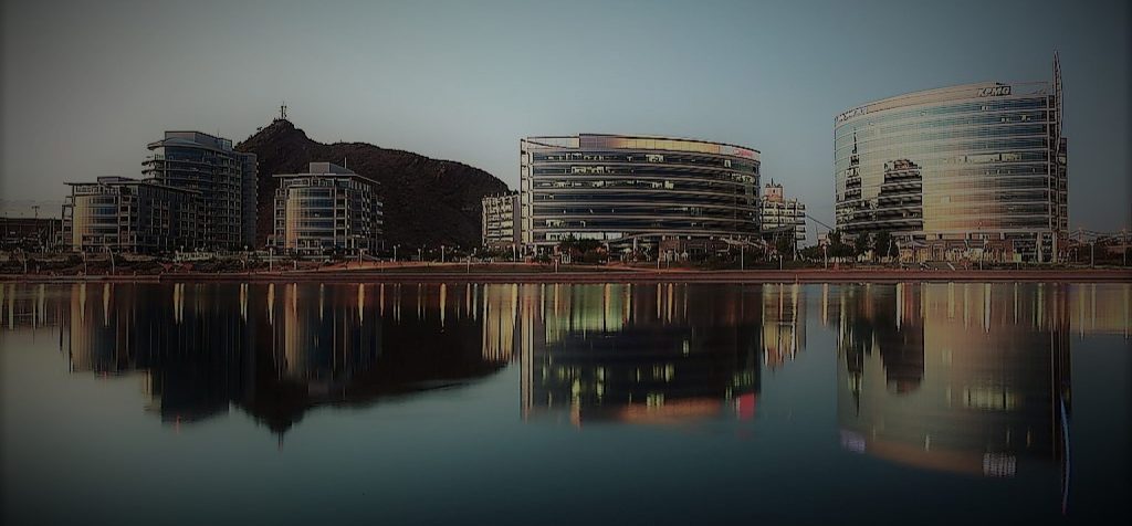 Commercial buildings along the water at dusk